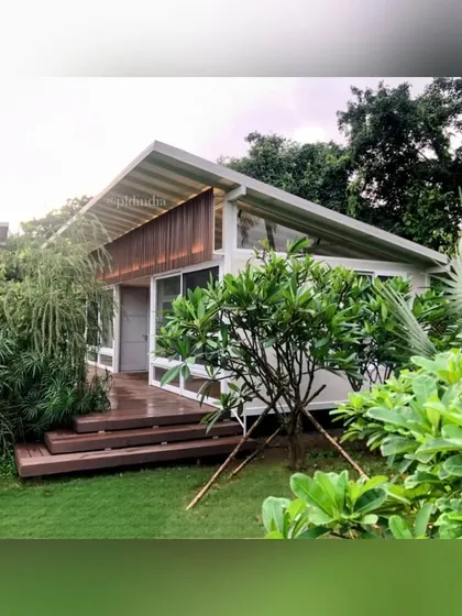 The home's architecture features clean lines and natural materials, which we complemented with a soft and lush landscape design. A young frangipani tree is planted near the deck, ready to add its fragrant blossoms to the garden.