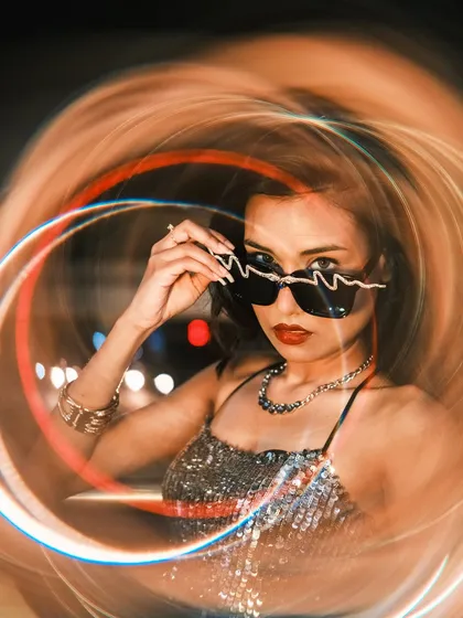A creative lifestyle portrait using a special warp filter to bend the city lights into a swirling vortex around the subject. This shows my experimental side, blending classic portraiture with modern, artistic techniques.