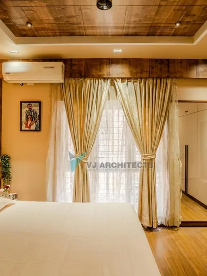 This bedroom view shows the full-length mirror integrated into the wardrobe design, a practical solution that also makes the room feel larger. The wooden ceiling adds a touch of rustic charm.