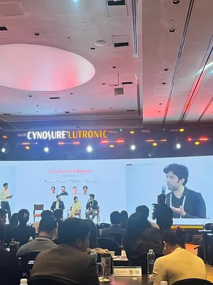 My work extends beyond the clinic to educating my peers. Here I am speaking at the Cynosure Lutronic APAC Summit, sharing my clinical experience and data on using advanced lasers for various conditions in Indian skin. Staying engaged with the global medical community ensures I bring the most current, evidence-based treatments back to my patients.