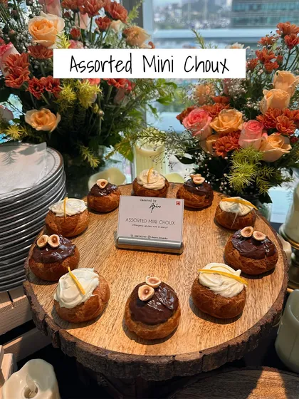 Sweet and savory perfection. These Assorted Mini Choux pastries are filled with delicious creams and topped with nuts, offering a delightful bite-sized dessert or a unique appetizer.