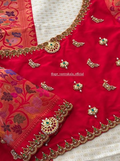 This view highlights the floral brocade sleeve paired with the red silk body of the blouse.