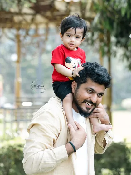 Another joyful shoulder ride, capturing a priceless father-son moment.