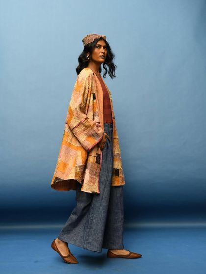 A profile shot in motion, capturing the beautiful movement of the jacket and pants. This image shows that slow fashion is made for a life in motion.