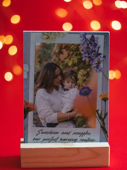 A mother and child photo on a custom stand, surrounded by beautiful floral illustrations and a loving message.