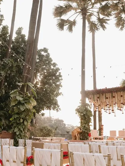 A wide shot of the ceremony space, showing the seating arrangement facing the sea, with the grand mandap as the focal point.