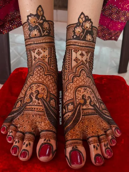 Peacock love for the feet. This design features bold peacocks as the central motif, surrounded by delicate patterns that create a beautiful contrast. The rich stain is simply gorgeous.