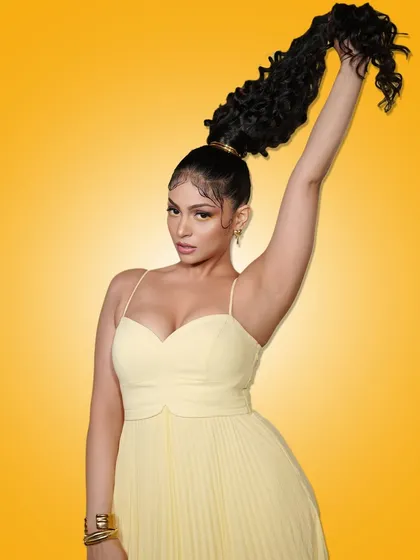 A confident pose from the model, highlighting her dramatic ponytail and summer glam.