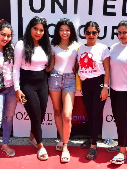 Guests posing on the red carpet at our Holi festival. We ensure a premium experience from the moment people walk in, with professional setups and photo opportunities.