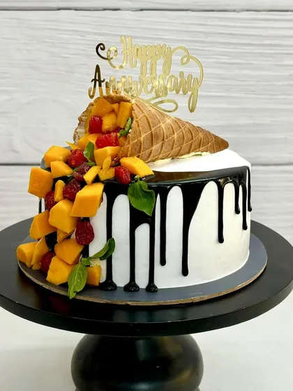 This is my most viral creation, the gravity-defying mango cone cake. It’s a perfect example of how I mix creative designs with delicious, fresh fruit flavors for a truly unique anniversary or birthday cake.