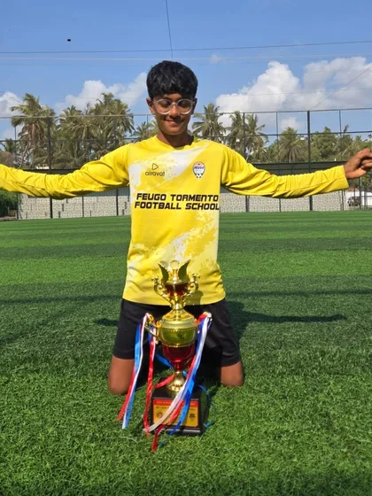 Our U14 goalkeeper celebrating with the championship trophy.