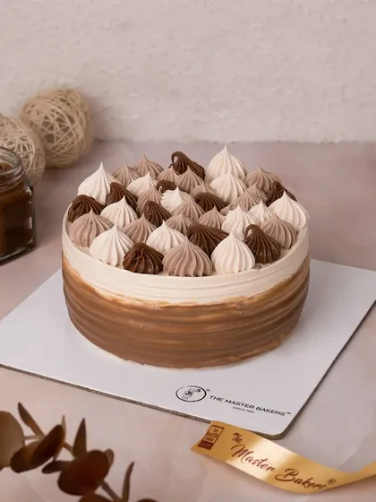 Our Choco Caramel Cake is a symphony of sweet and rich flavors. We decorate it with beautiful two-toned swirls of chocolate and caramel frosting, creating a simple yet elegant look.