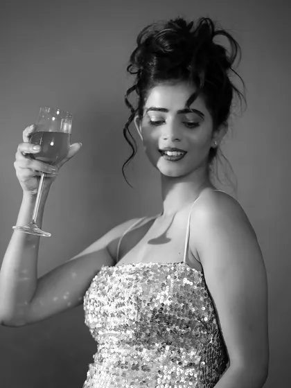 A glamorous black and white portrait. The sequin dress creates a beautiful texture, and the wine glass adds a touch of classic Hollywood elegance.