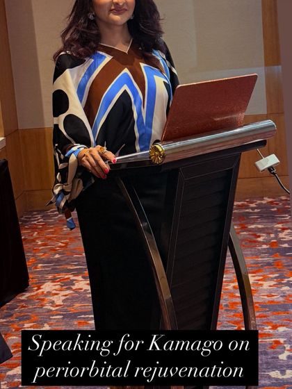 Speaking on Periorbital Rejuvenation. A photo of me at the podium, delivering a lecture for Kamago on the latest techniques for rejuvenating the delicate skin around the eyes.