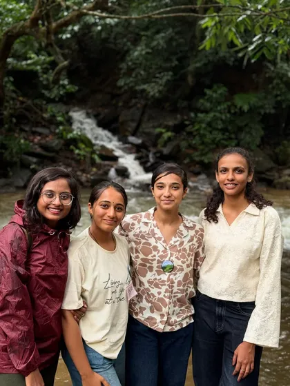 A group of friends posing by a stream on the Bandaje trail.