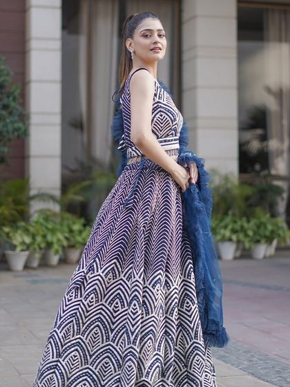 A full-length shot of the navy and white lehenga, highlighting its unique pattern and flattering A-line shape. It's a perfect blend of modern design and traditional silhouette.