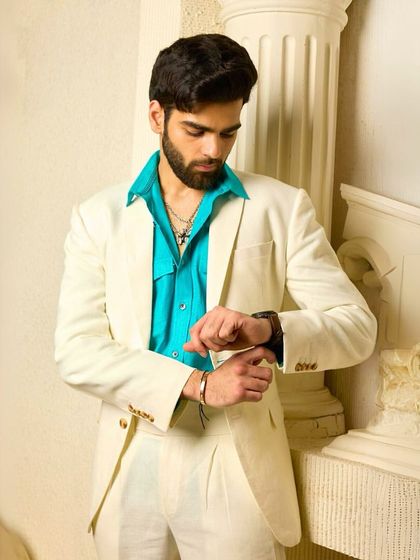 A moment of preparation in the off-white suit. The comfortable fit and luxurious fabric make it the perfect choice for a long day of events where style cannot be compromised.