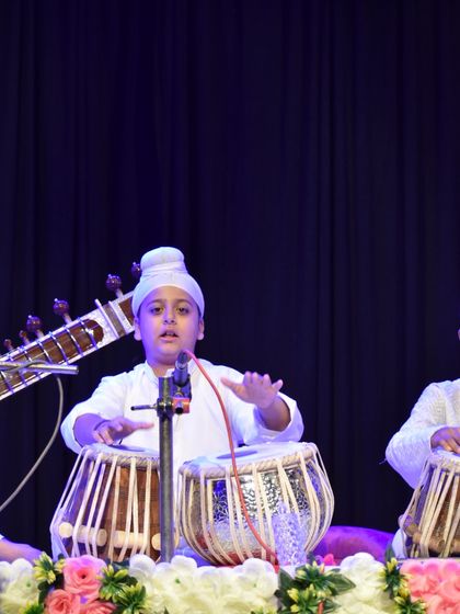 A close-up of a young student performing with intense focus during a concert. We nurture dedication and discipline from an early age.