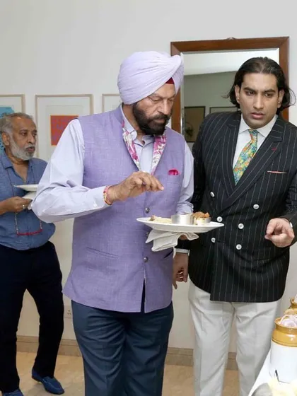 Discussing a dish with a guest at an elite gathering. I make it a point to interact with guests to ensure their experience is exceptional.