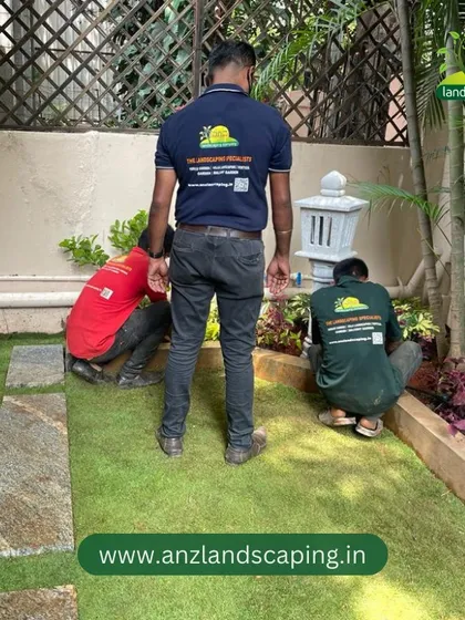 Our gardeners are shown carefully placing plants in a border garden, a crucial step in bringing our custom landscape designs to life.