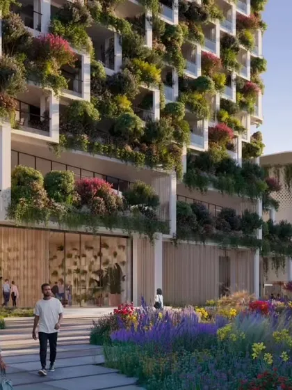 The entrance to one of the Sky Gardens towers, where the lush landscaping of the ground floor merges with the vertical gardens of the facade.