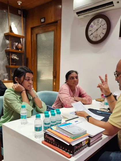 Here I am in a personal consultation session, explaining the details of a numerology report. I believe in a hands-on approach, analyzing every detail myself rather than using software. This allows me to connect with my client's story and provide truly personalized and heartfelt guidance for their life, career, and relationships.