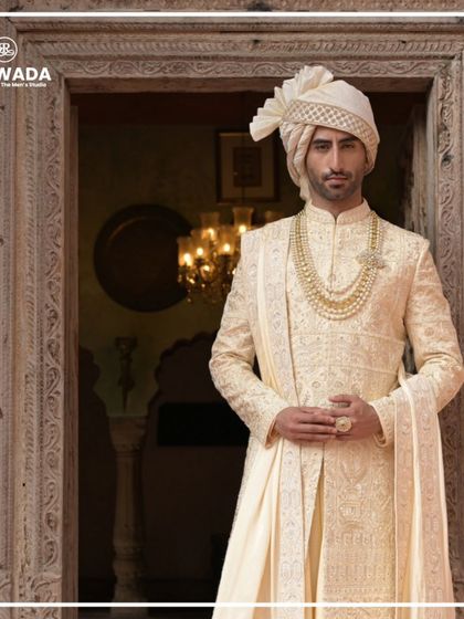 A close-up portrait of a groom in his Shauhar attire. The focus on the safa, the layered necklace, and the detailed collar embroidery highlights the complete regal look.