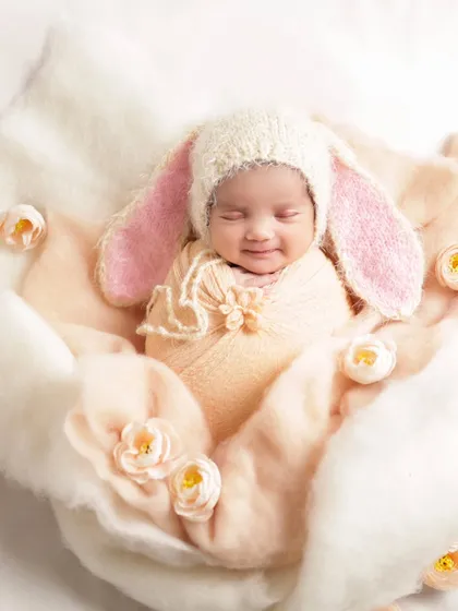 That little smile in their sleep is just the most precious thing. We gently posed this sweet newborn with a soft bunny theme, creating a dreamy and innocent portrait. These are the moments that fly by so fast.