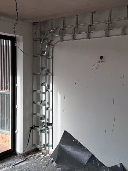 A work-in-progress shot showing the metal framework being installed for a custom wall feature in 'Project Lily'.