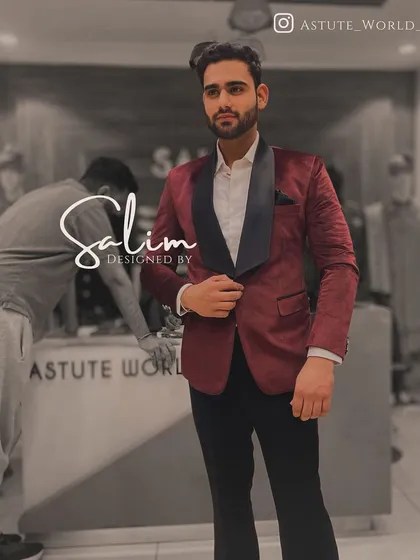A client in a classic maroon velvet tuxedo jacket with a black shawl lapel. This is a rich and elegant choice for any formal winter event.