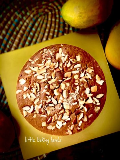 Another view of the vegan mango nuts cake, showing the generous topping of nuts.