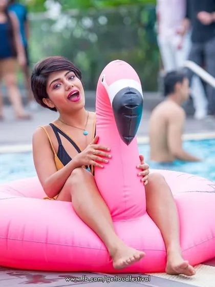 A guest having fun with a pink flamingo float. The props make the party even more memorable.