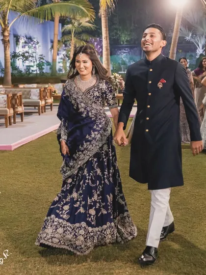 The happy couple making their entrance at the reception. Their smiles show the success of a perfectly planned event where they can simply enjoy their moment.