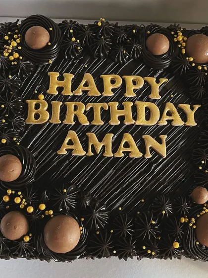 A classic square chocolate brownie cake, personalized for Aman's birthday. I use rich, dark chocolate frosting and can add custom messages in elegant lettering to make your celebration cake truly personal. This is one of my most popular eggless birthday cakes.