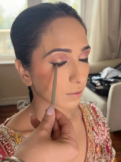 A clean, sharp winged eyeliner is a timeless skill. Here, I'm using a fine-tipped brush to create a precise line, a fundamental technique I cover in my one-on-one lessons.