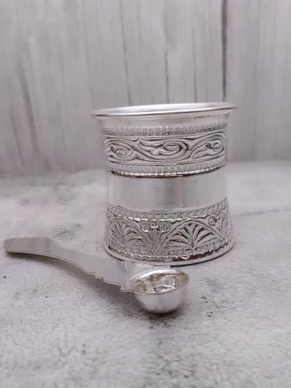 Another angle of the German silver panchapatra, showing the fine engravings on the glass.