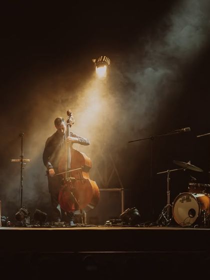 An atmospheric shot of Anoushka Shankar's band, with a single spotlight creating a warm, intimate mood.