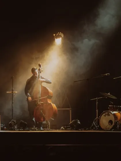 An atmospheric shot of Anoushka Shankar's band, with a single spotlight creating a warm, intimate mood.