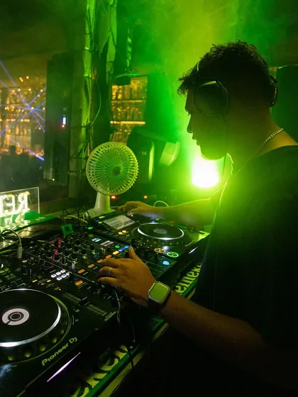 Behind the decks at the Frat House Party, surrounded by a sea of people. This is my office.
