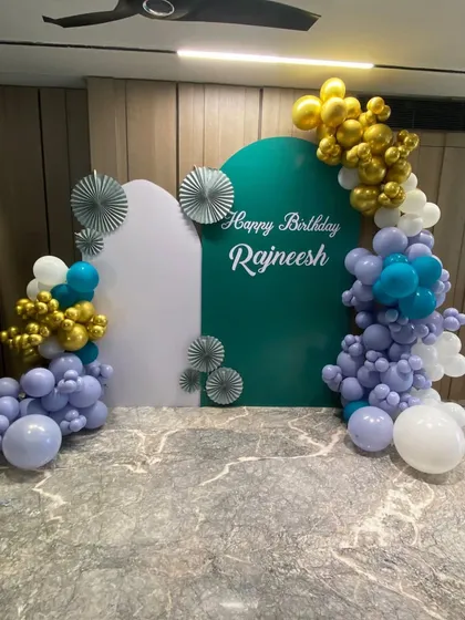 Another angle of the elegant 50th birthday decor for Rajneesh, showing how the different elements like the balloon garland, custom panels, and lighting come together to transform a space.