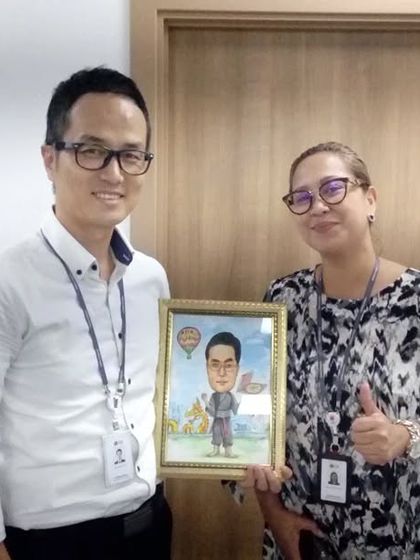 A happy client receiving a surprise caricature gift for their boss.