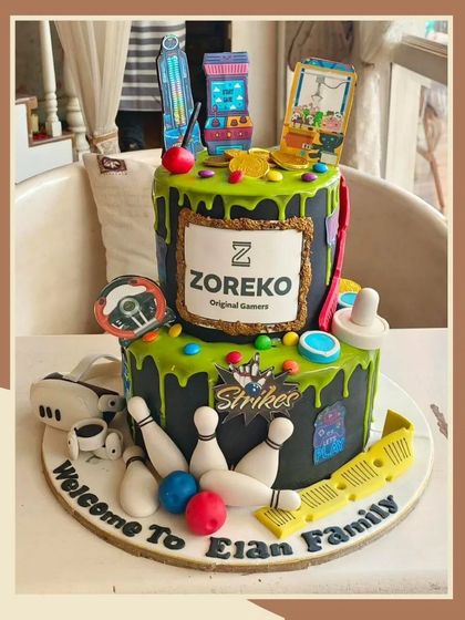 A fun and detailed gaming-themed cake with elements of bowling, arcade games, and a VR headset.