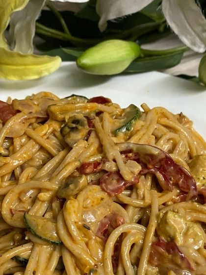 A hearty bowl of spaghetti tossed in a creamy sauce with sun-dried tomatoes, zucchini, and mushrooms. We offer a range of pasta dishes that can be customized for your event.