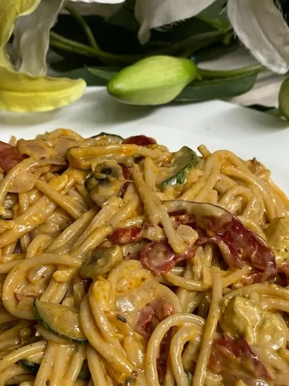 A hearty bowl of spaghetti tossed in a creamy sauce with sun-dried tomatoes, zucchini, and mushrooms. We offer a range of pasta dishes that can be customized for your event.