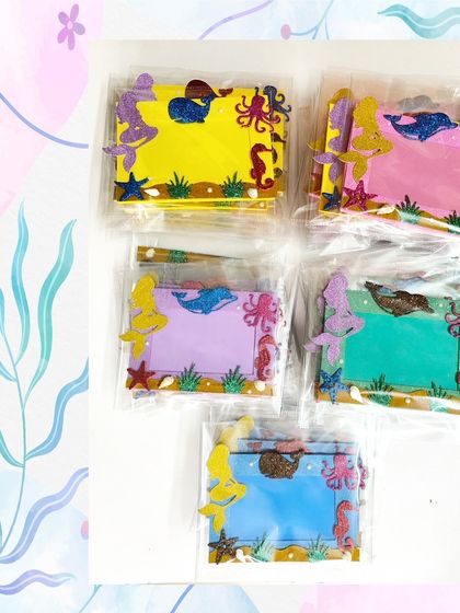 Here are the mermaid photo frames packaged and ready to go. They come in assorted background colors like yellow, pink, purple, and blue.