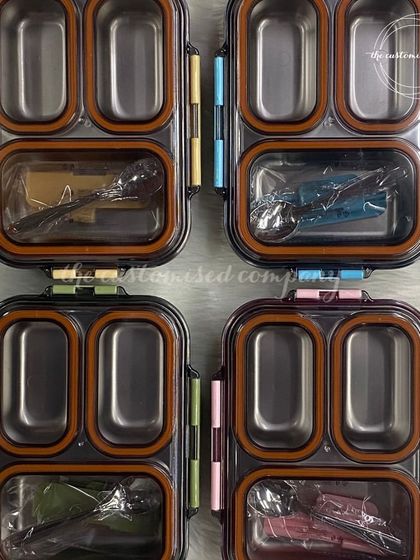 A top-down view of our stainless steel, multi-compartment lunch boxes. The silicone seals ensure they are leak-proof, making them a practical and long-lasting choice for kids' meals.