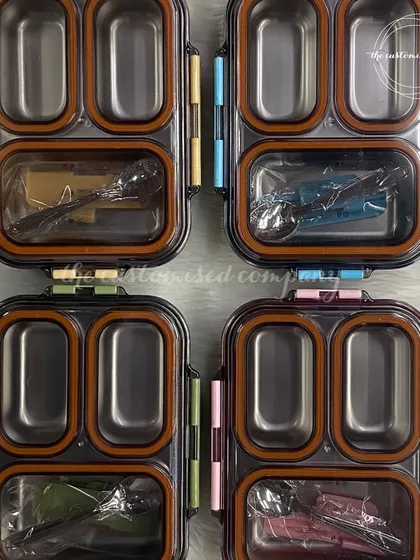 A top-down view of our stainless steel, multi-compartment lunch boxes. The silicone seals ensure they are leak-proof, making them a practical and long-lasting choice for kids' meals.