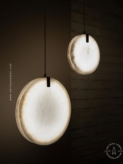 Showcasing our disc-shaped marble pendants. The light emanates softly through the thin slice of natural marble, revealing its unique veining. These fixtures are available in different shapes and look stunning hung in pairs or trios.