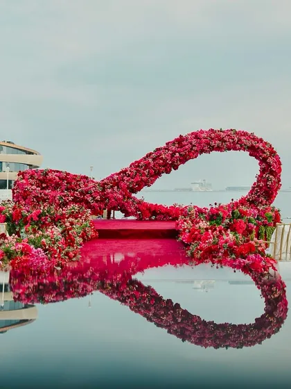 A life-sized infinity floral installation we designed for a beach wedding in Doha, Qatar, reflecting perfectly in the water. We love pushing creative boundaries to create unique, symbolic decor that tells your love story, wherever you choose to say "I do".