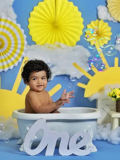 Bubbles make everything more fun. This little one is enjoying a bubble bath in our sunshine-themed setup, perfect for a first birthday.